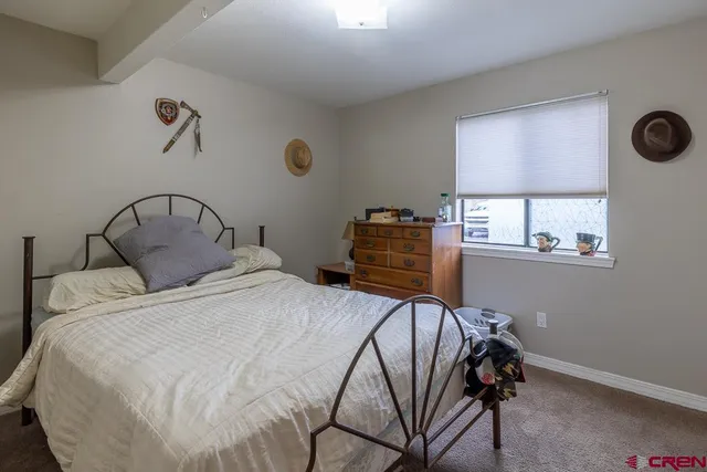 a view of a workspace with furniture and a bookshelf