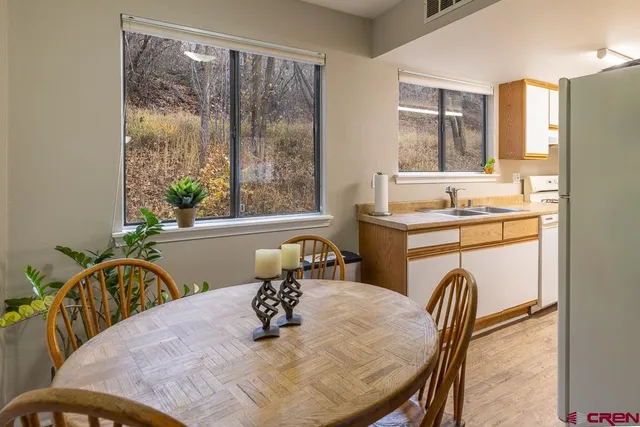 a view of a dining room with furniture window and outside view