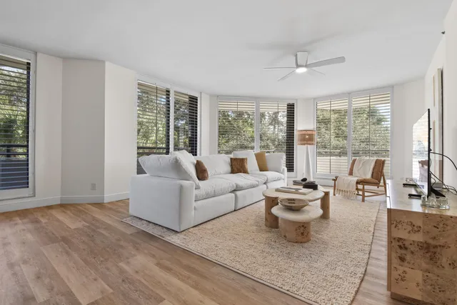 a living room with furniture and large windows