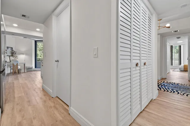 a view of a hallway with wooden floor