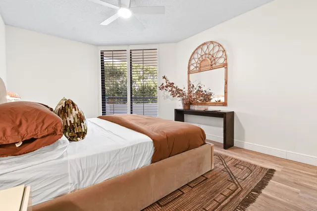 a bedroom with a bed and a painting on the wall