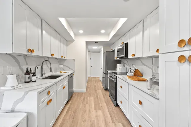 a kitchen that has a sink and a stove in it
