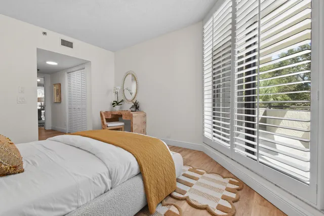 a bedroom with a bed and a window