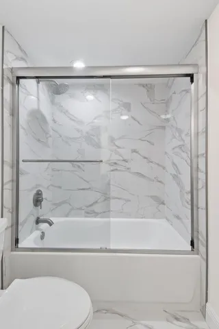 a bathroom with a shower and a toilet