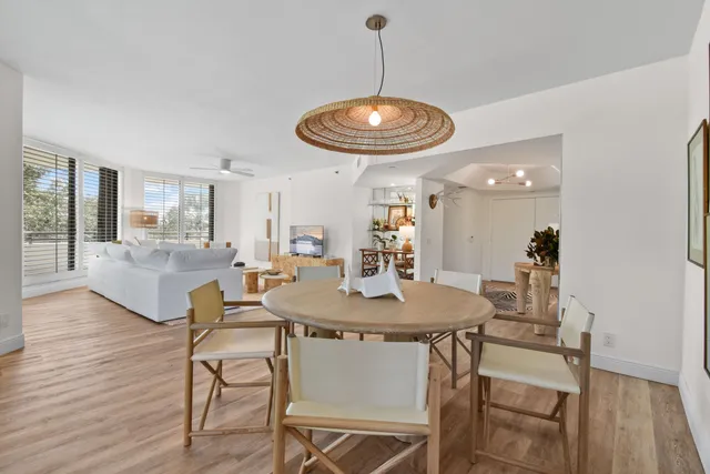 a view of a dining room with furniture wooden floor and chandelier
