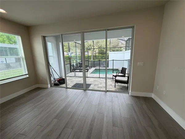 a living room with hardwood floor and a balcony