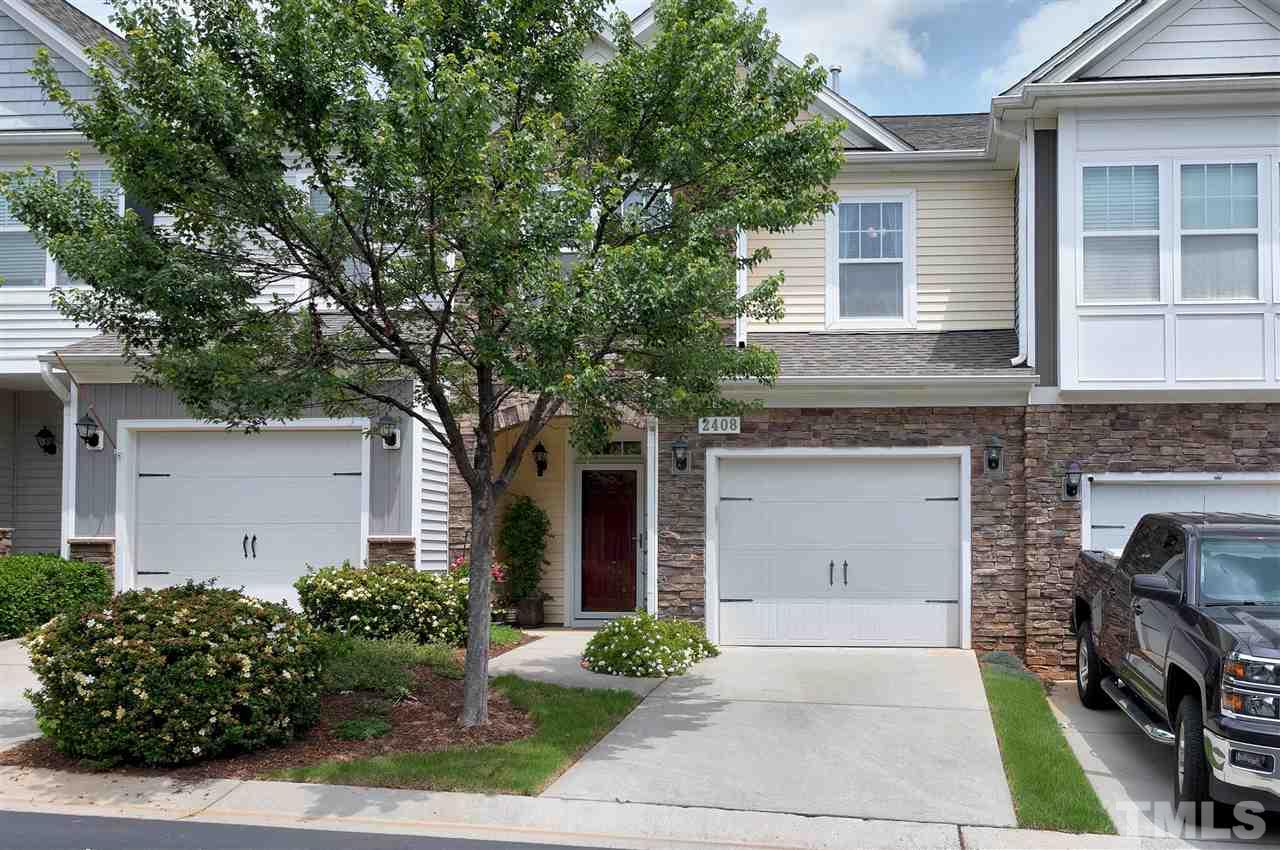 2408 Memory Ridge Drive Raleigh, NC 27606 - Photo 2 of 30 a front view of a house with a garden and plants