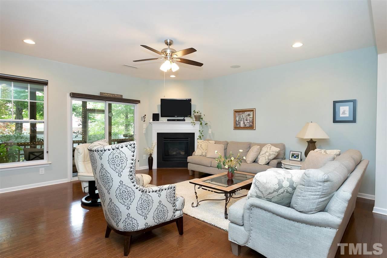 2408 Memory Ridge Drive Raleigh, NC 27606 - Photo 10 of 30 a living room with furniture a fireplace and a flat screen tv