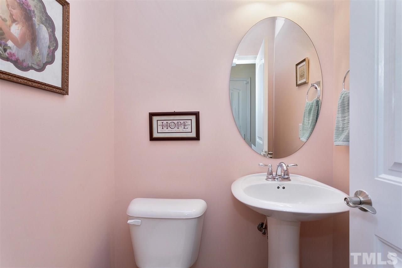 2408 Memory Ridge Drive Raleigh, NC 27606 - Photo 16 of 30 a bathroom with a toilet sink and mirror