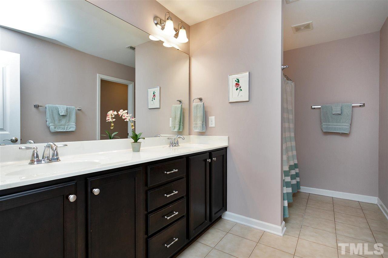 2408 Memory Ridge Drive Raleigh, NC 27606 - Photo 20 of 30 a bathroom with a double vanity sink and a mirror
