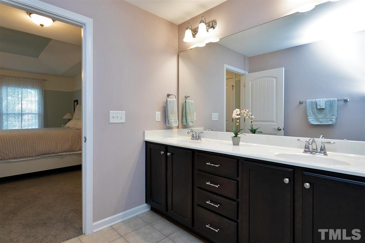 2408 Memory Ridge Drive Raleigh, NC 27606 - Photo 21 of 30 a bathroom with a double vanity sink and a mirror