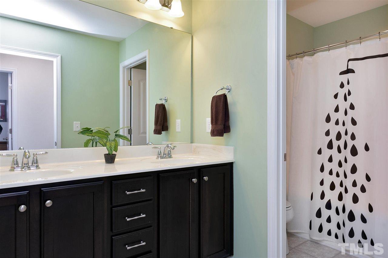 2408 Memory Ridge Drive Raleigh, NC 27606 - Photo 24 of 30 a bathroom with a double vanity sink and mirror