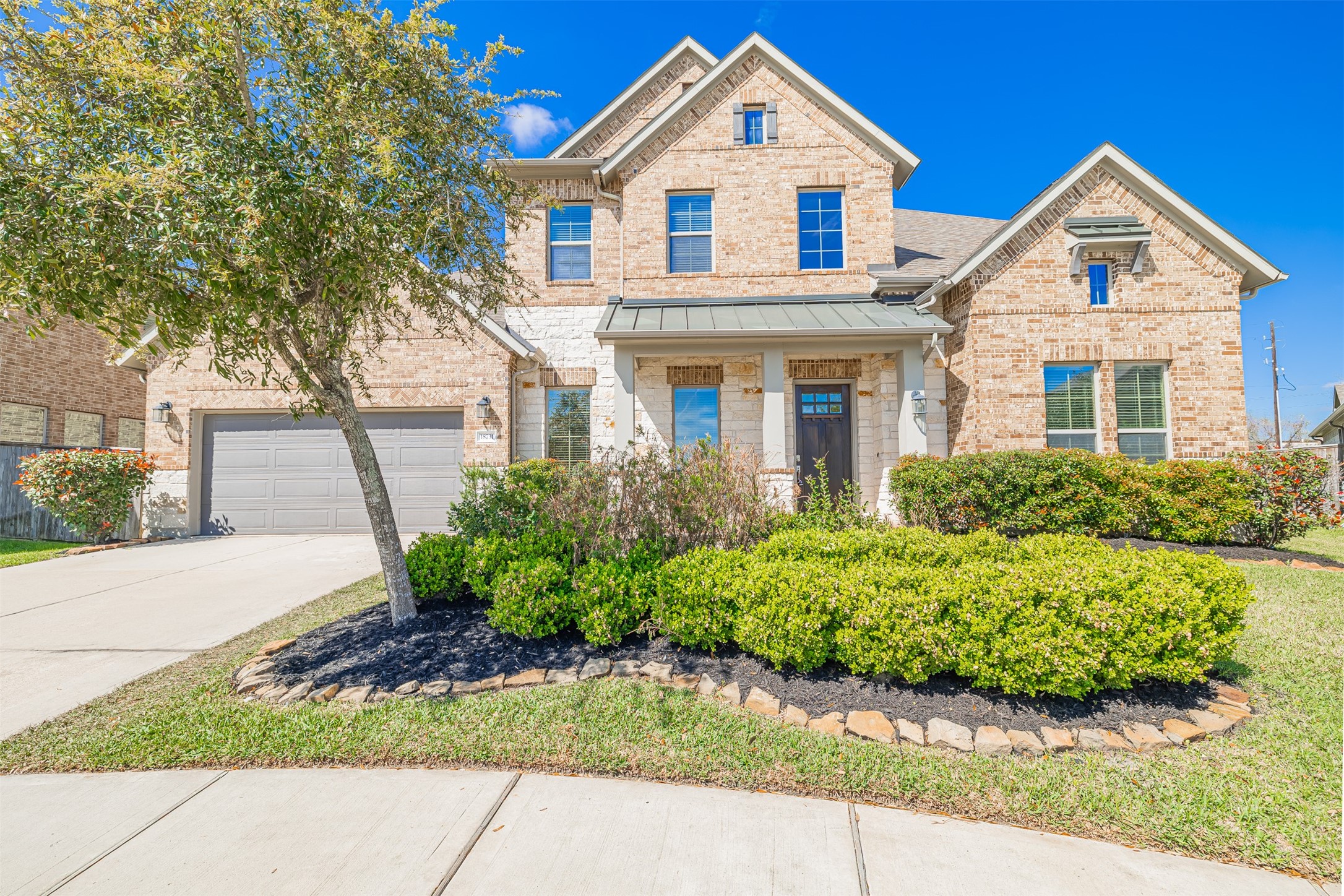 Beautifully designed 4-bedroom, 4.5-bath home with a brick and stone elevation.