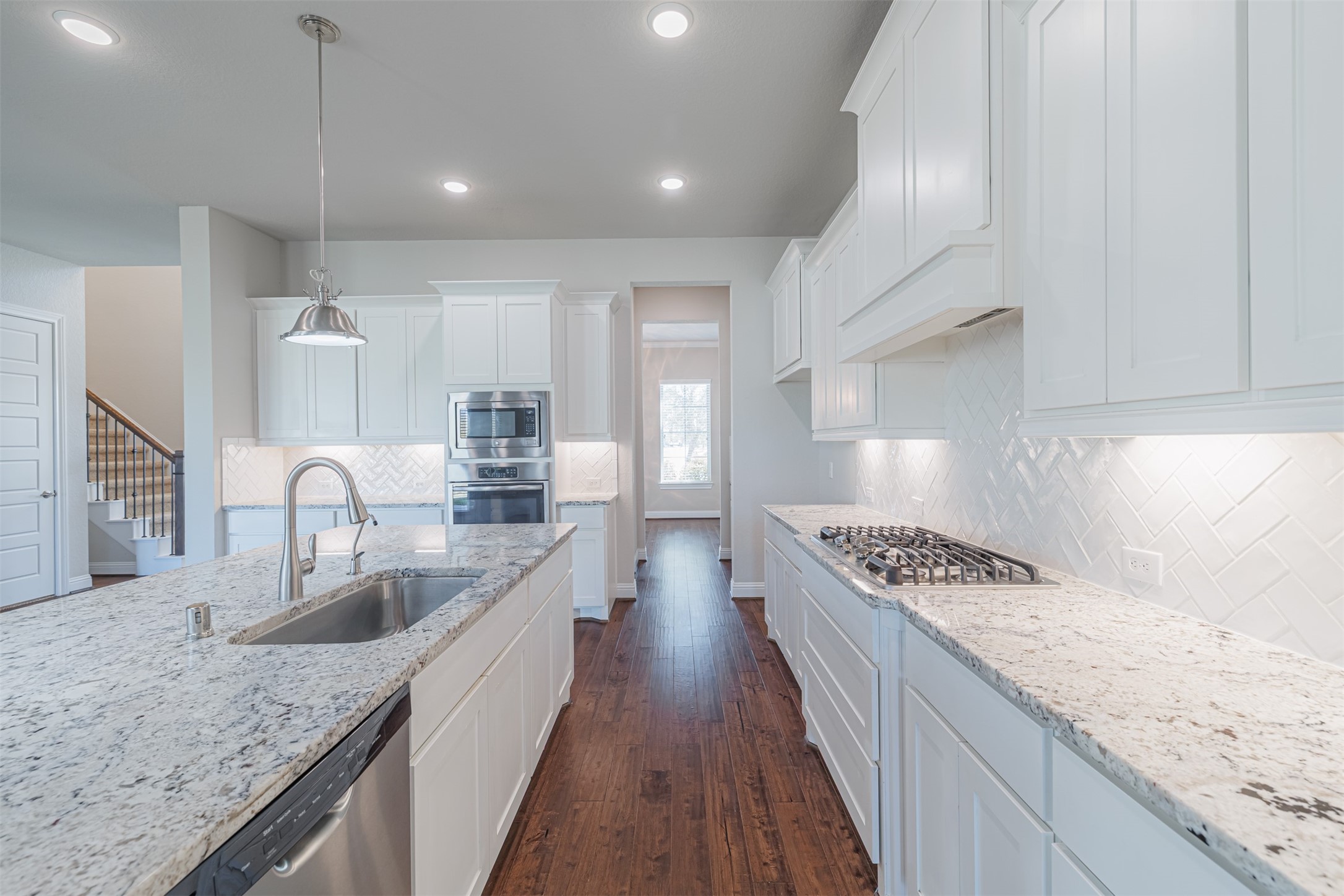 18731 Spellman Ridge Drive Tomball, TX 77377 - Photo 15 of 50 Kitchen has under-cabinet lighting, gas cooking and stainless steel appliances.