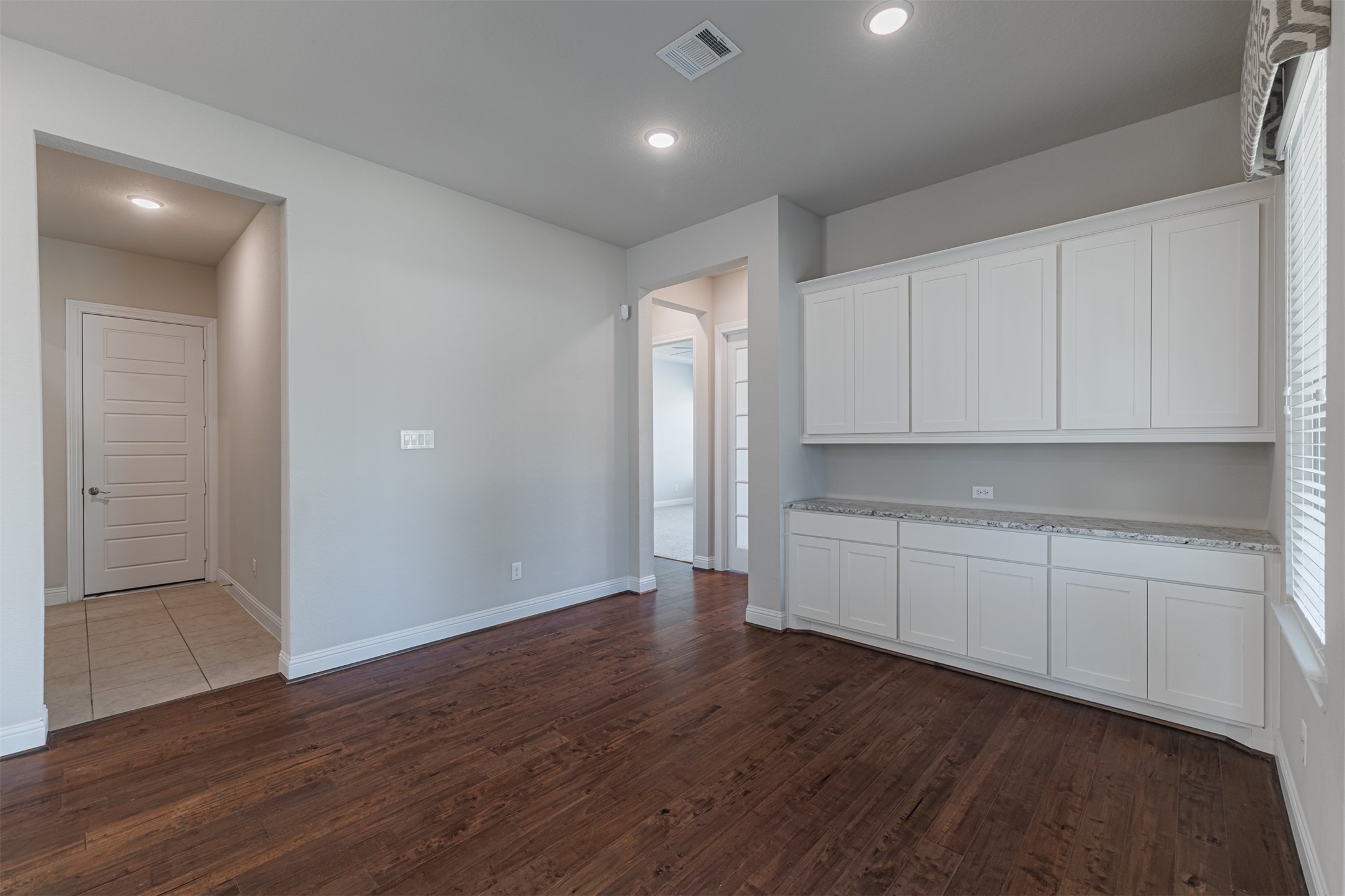 18731 Spellman Ridge Drive Tomball, TX 77377 - Photo 18 of 50 Breakfast room with wood flooring and built-in cabinetry.