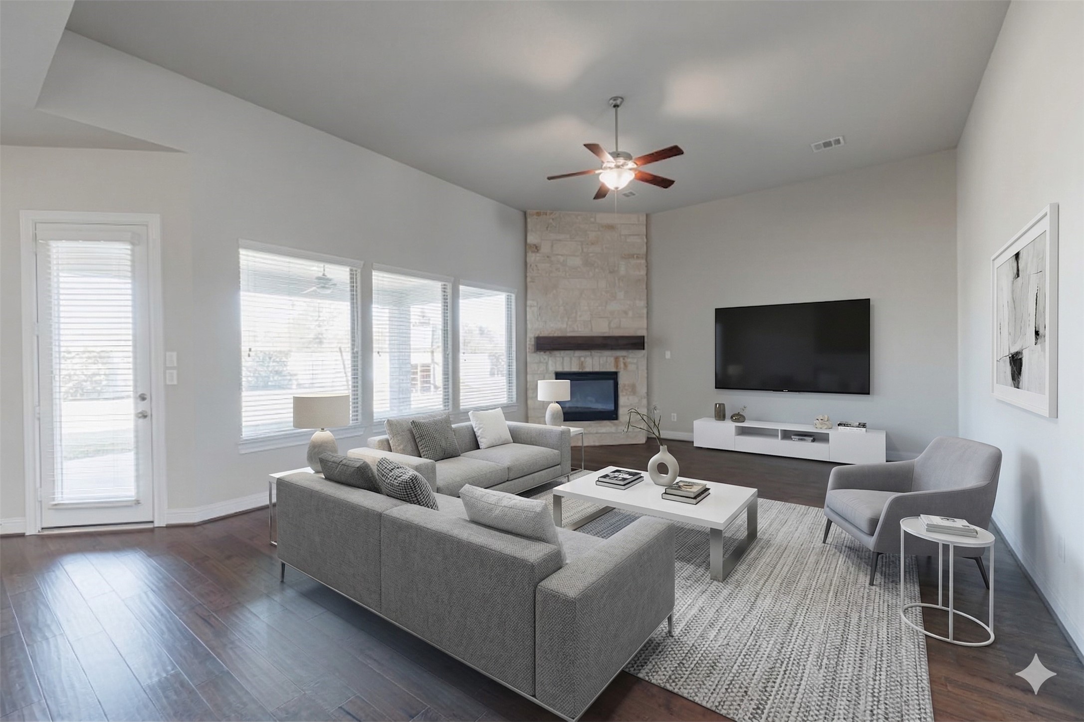 18731 Spellman Ridge Drive Tomball, TX 77377 - Photo 20 of 50 Spacious family room with wood flooring and a striking stone surround gas-log fireplace. - Virtually Staged.