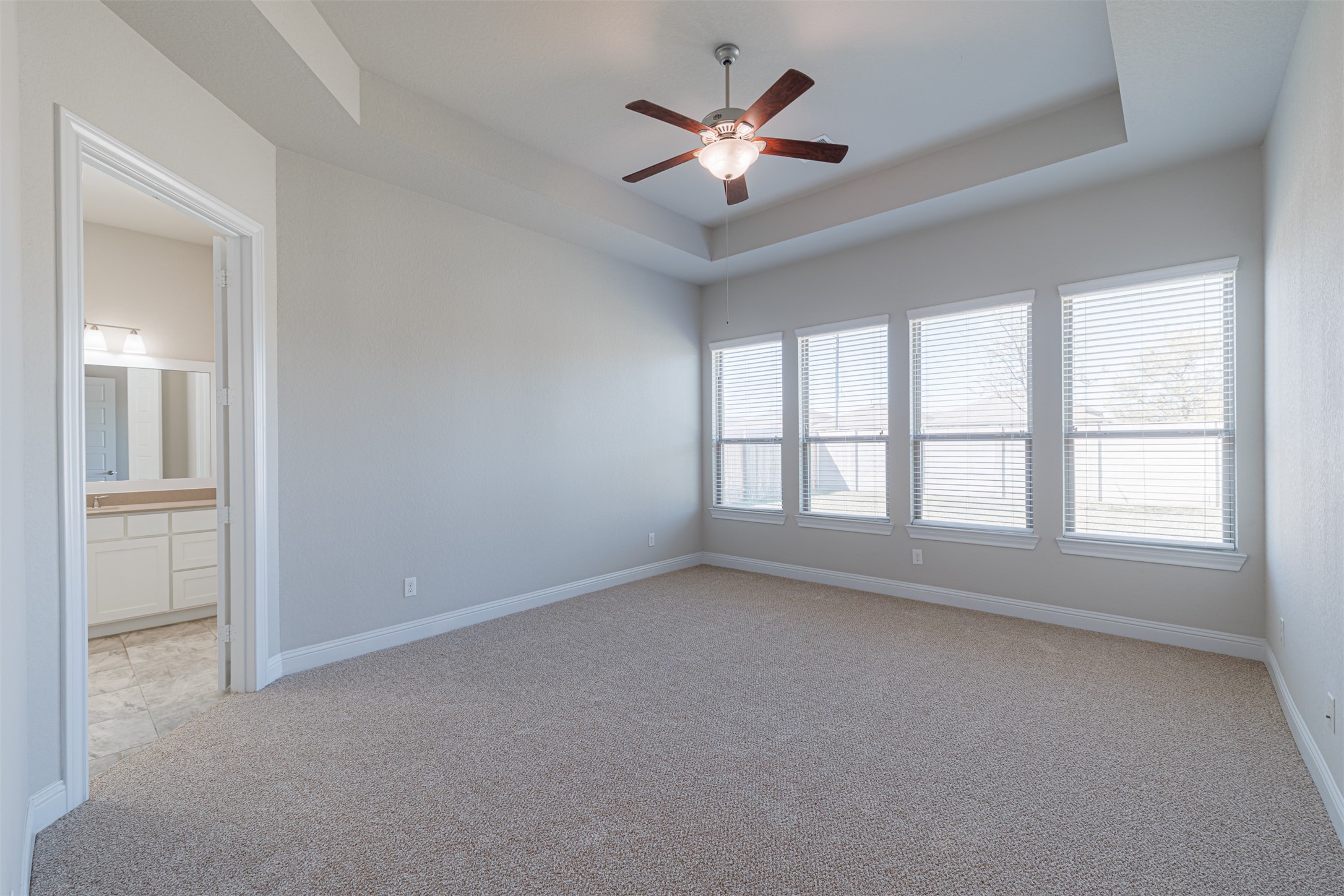 18731 Spellman Ridge Drive Tomball, TX 77377 - Photo 27 of 50 The primary suite offers high tray ceilings and an ensuite bath.