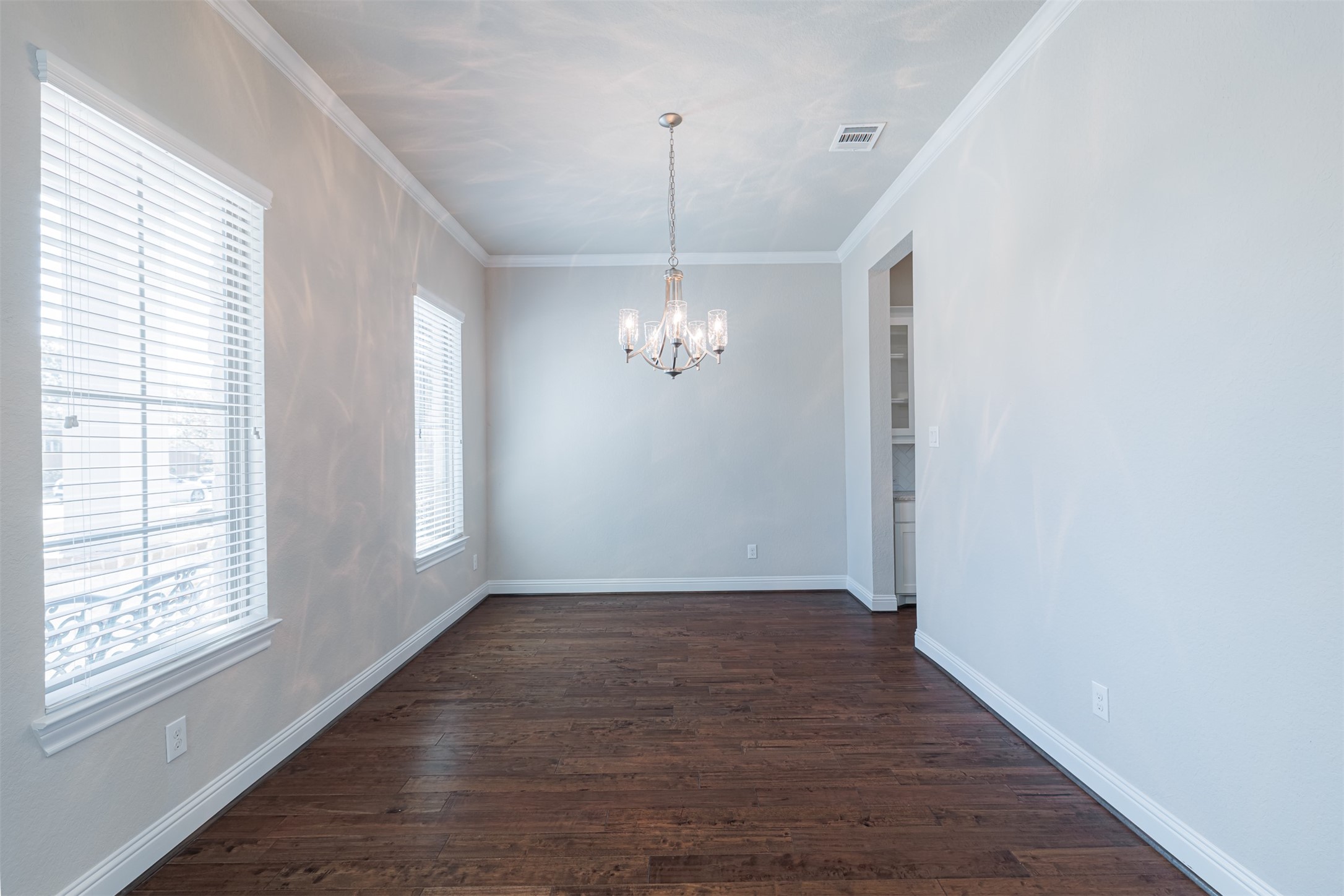 18731 Spellman Ridge Drive Tomball, TX 77377 - Photo 10 of 50 Formal dining room with wood flooring and crown molding.