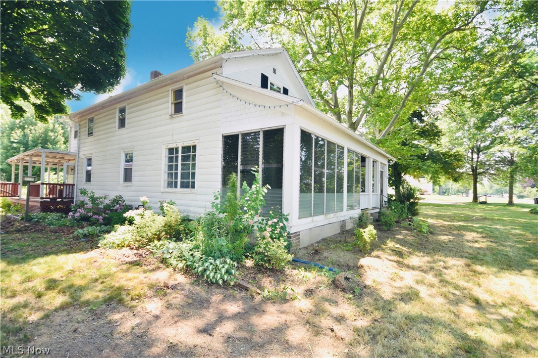 5694 Middle Ridge Road Madison, OH 44057 - Photo 24 of 27 Rear view of property with a yard and a sunroom