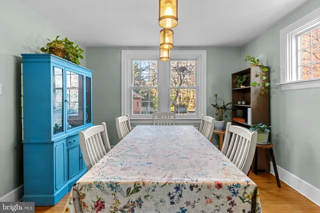 a view of a bedroom with wooden floor and windows