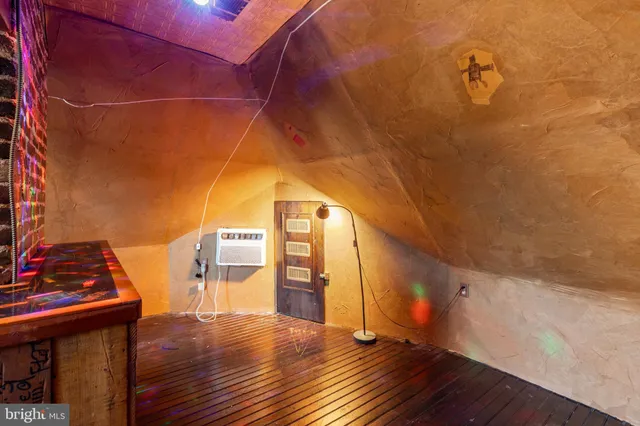 a view of a livingroom with workspace and a window