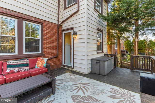 a view of backyard with deck and outdoor seating