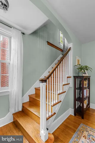 a view of entryway and hall with wooden floor