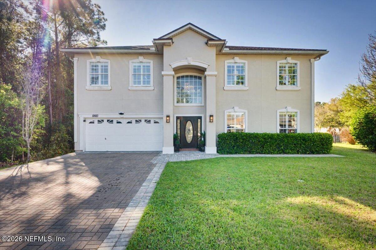 a front view of a house with a yard and garage