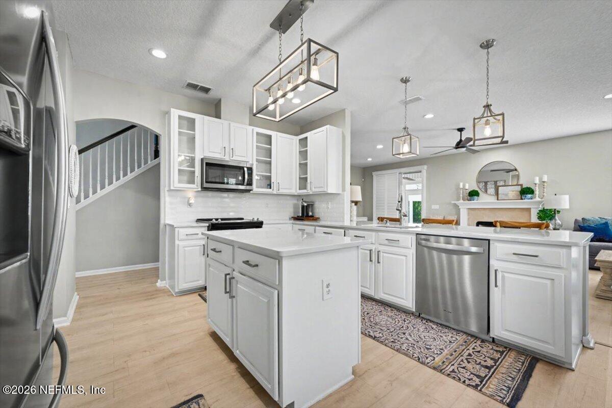 12683 Arrowleaf Lane Jacksonville, FL 32225 - Photo 11 of 52 a kitchen with cabinets stainless steel appliances and wooden floor