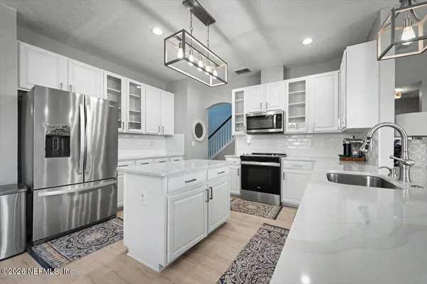 a kitchen with a sink cabinets and window