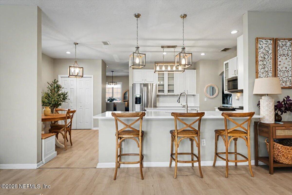 12683 Arrowleaf Lane Jacksonville, FL 32225 - Photo 15 of 52 a dining room filled chandelier and wooden floor