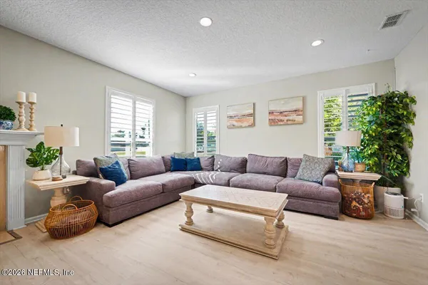 a living room with furniture a flat screen tv and a fireplace