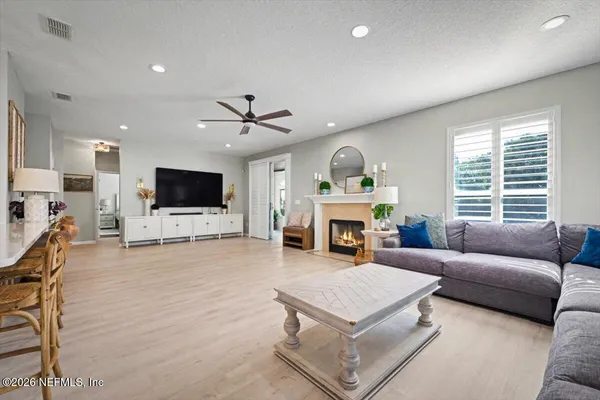 a living room with furniture and a fireplace