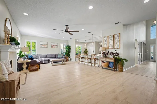 a view of a porch with chairs and potted plants