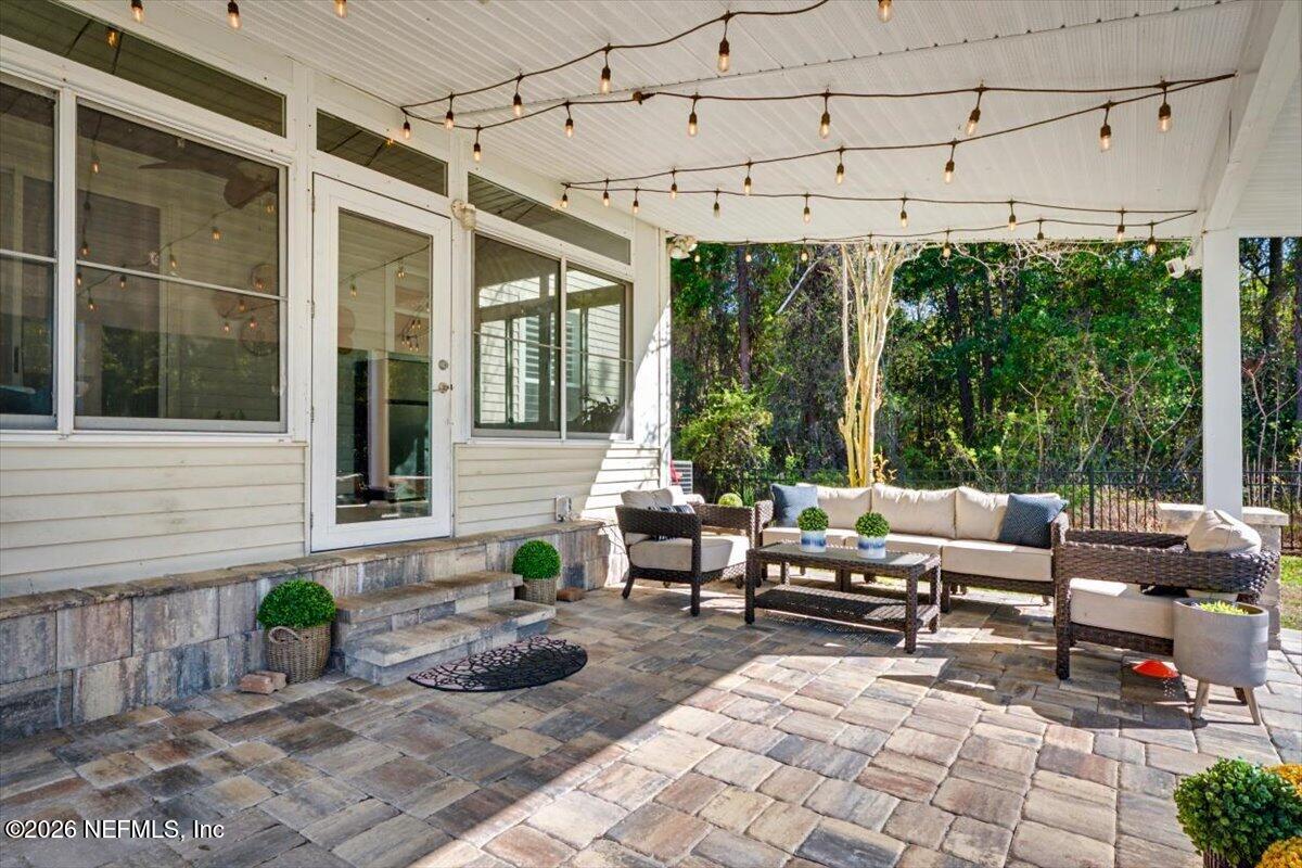 12683 Arrowleaf Lane Jacksonville, FL 32225 - Photo 24 of 52 a living room with patio furniture and floor to ceiling windows