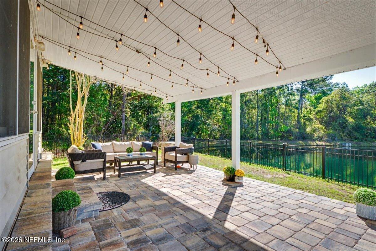 12683 Arrowleaf Lane Jacksonville, FL 32225 - Photo 25 of 52 a view of a patio with a table chairs and a backyard