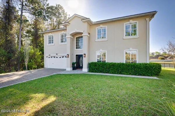 a front view of a house with a yard