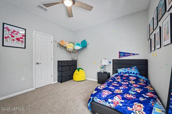 a bedroom with a large bed and a window