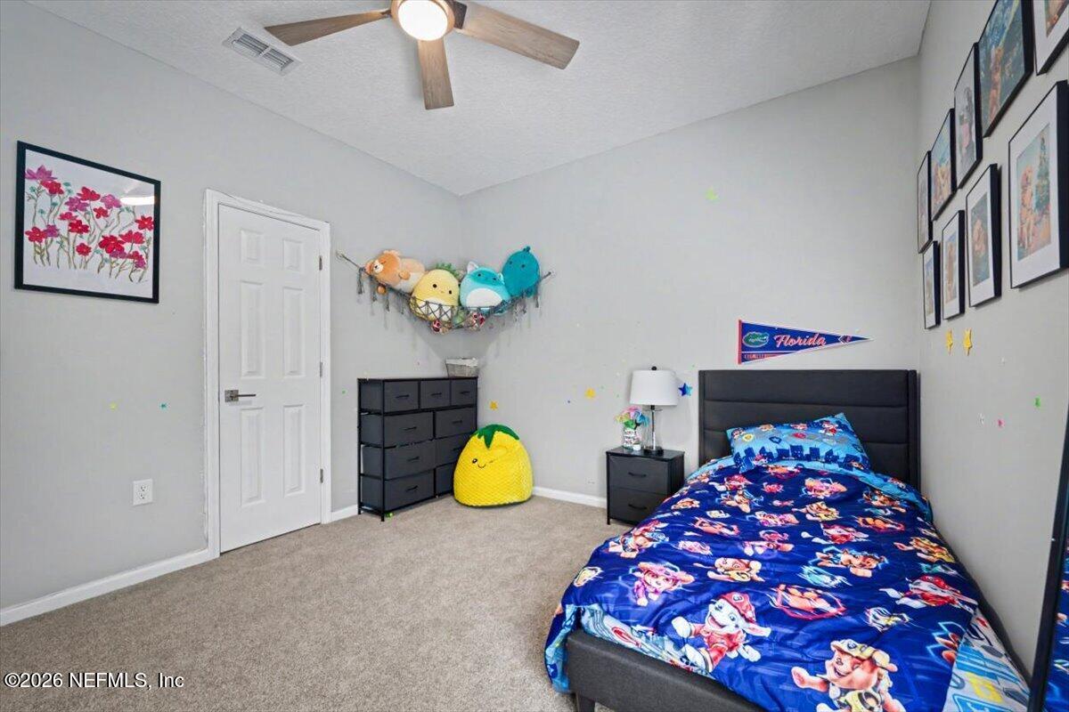 12683 Arrowleaf Lane Jacksonville, FL 32225 - Photo 37 of 52 a bedroom with two beds and a chandelier
