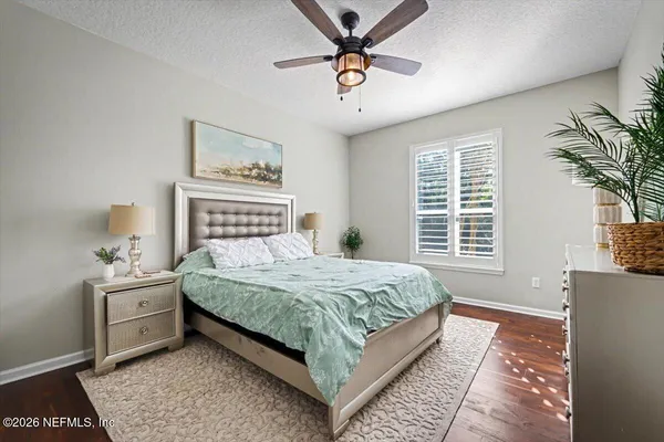 a bedroom with bed and paintings on the wall