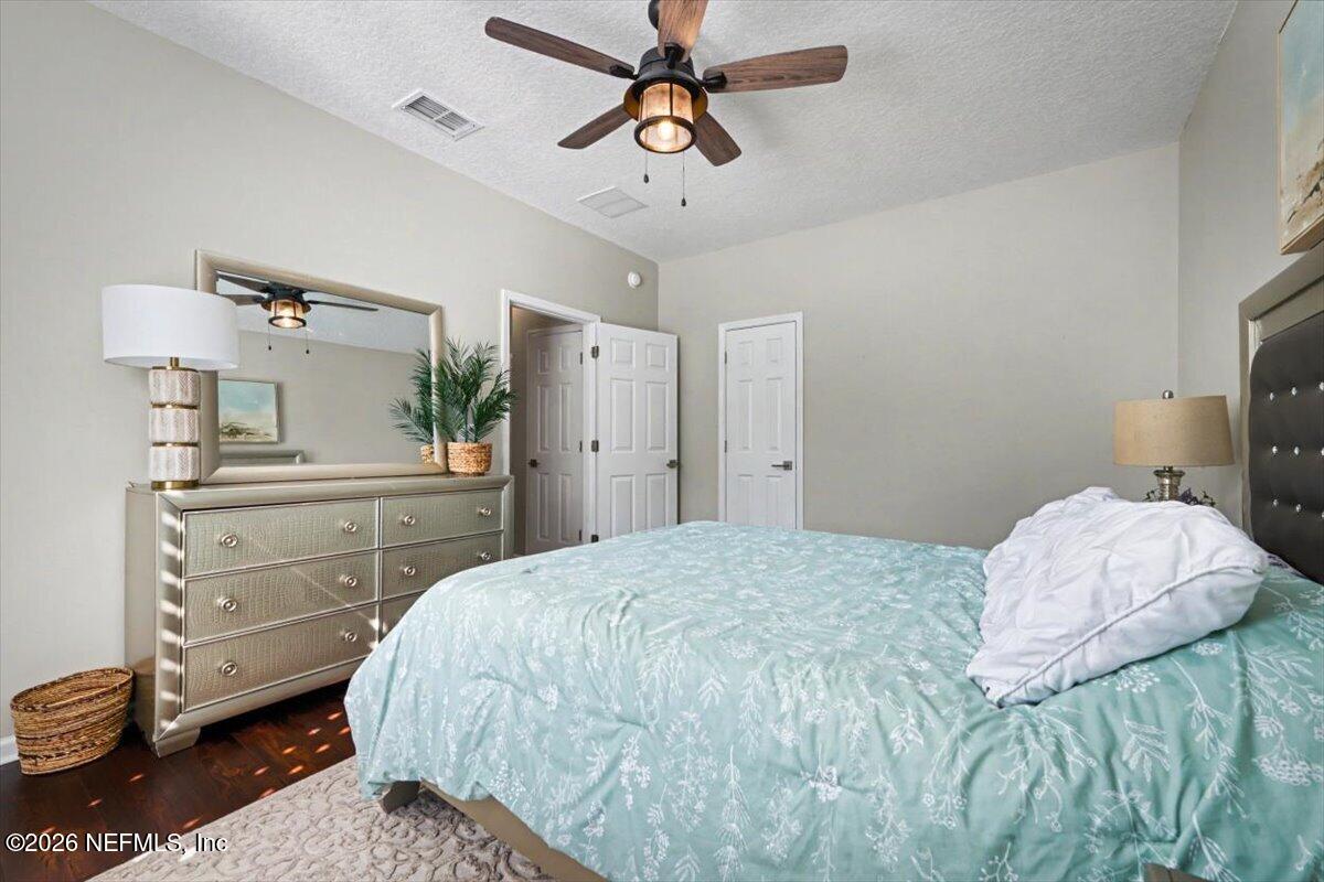 12683 Arrowleaf Lane Jacksonville, FL 32225 - Photo 40 of 52 a bedroom with a bed and a chandelier