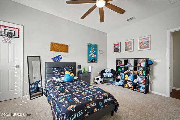 a bedroom with furniture and a window