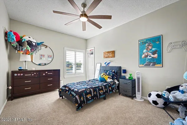 a bedroom with furniture and a window