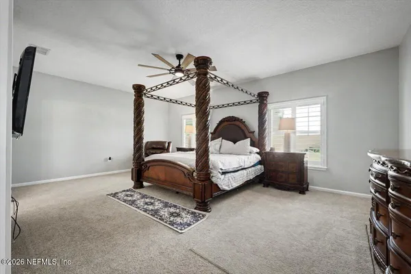 a spacious bathroom with a granite countertop double vanity and a mirror