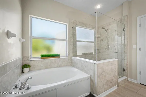 a view of a patio with table and chairs potted plants and large tree