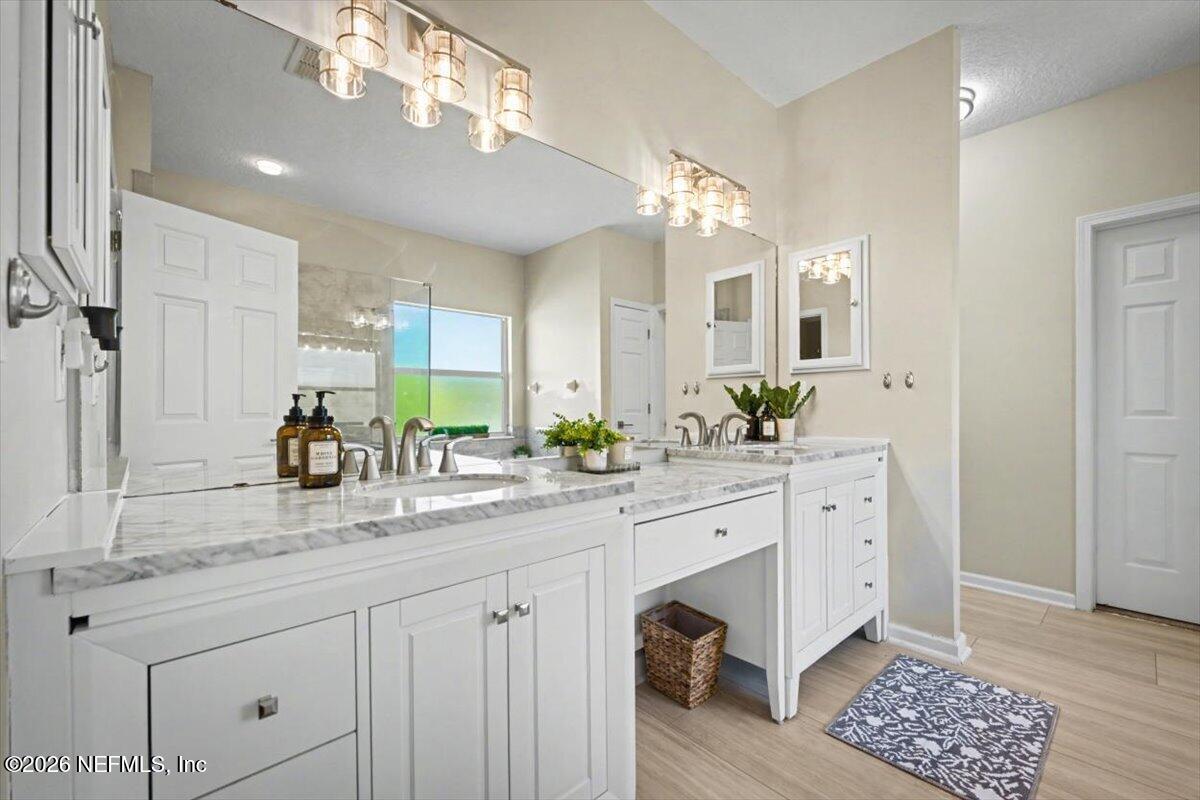 12683 Arrowleaf Lane Jacksonville, FL 32225 - Photo 46 of 52 a spacious bathroom with a granite countertop double vanity and a mirror