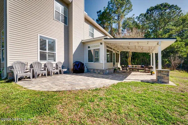 a view of a house with swimming pool and sitting area