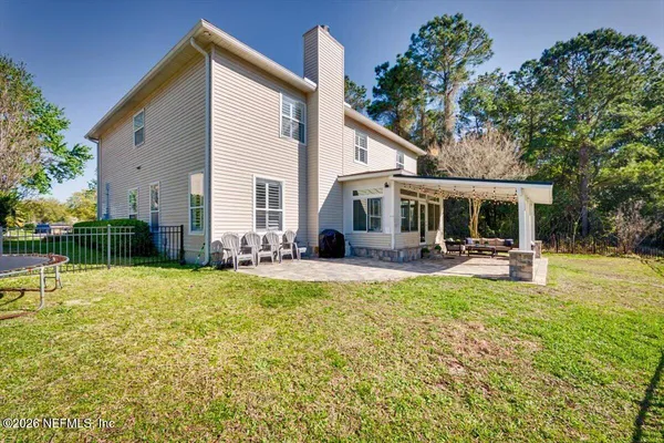 a view of a house with a yard and garage