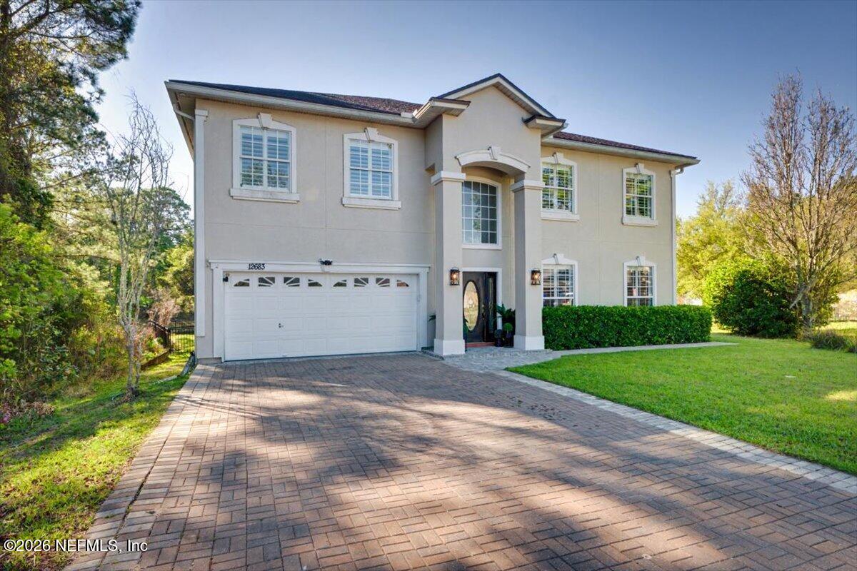 12683 Arrowleaf Lane Jacksonville, FL 32225 - Photo 51 of 52 a view of a house with a yard and garage