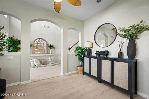 a living room with furniture and a potted plant